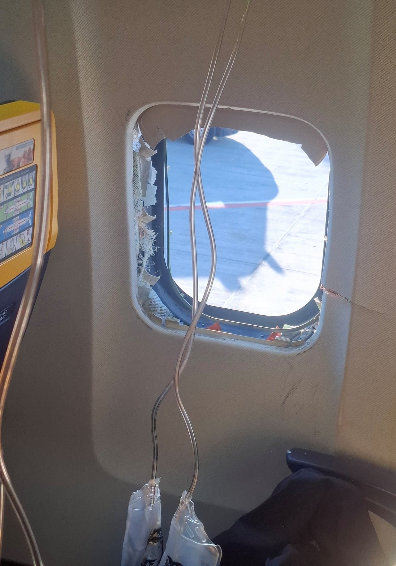 A broken window is seen on an aircraft.
