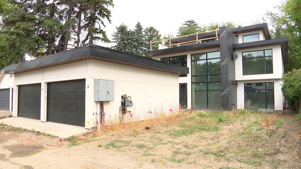 default-276 A nearly completed large flat-roofed house and garage.