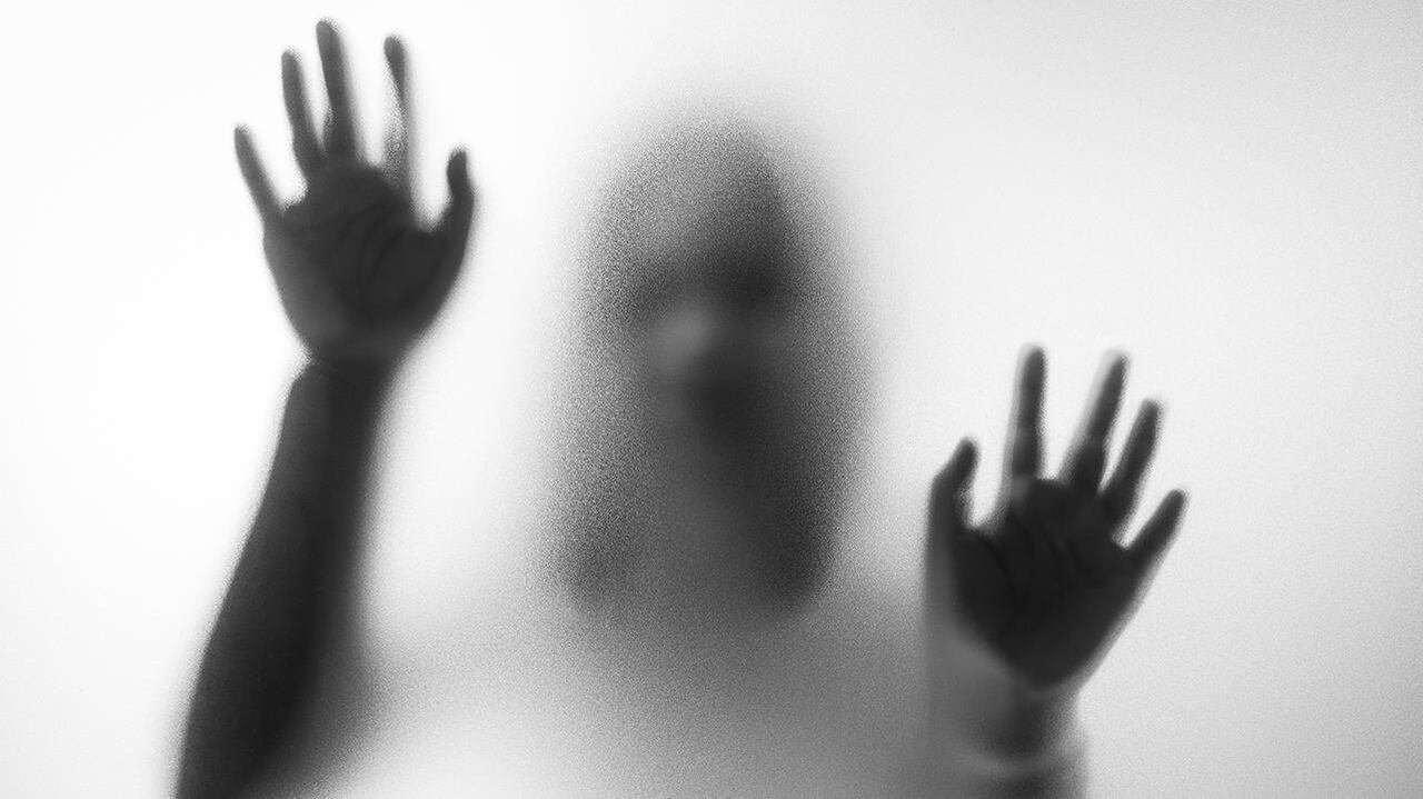 default-96 Blurry hands and body figure abstraction that looks like a ghost standing behind a glass pane with with her hands on it